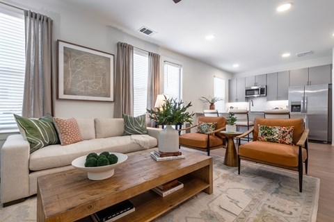 A modern living room with a wooden coffee table and a grey sofa.